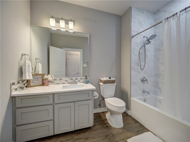 full bath with toilet, shower / bath combo with shower curtain, decorative backsplash, vanity, and wood finished floors