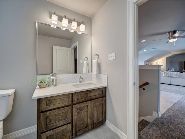 ensuite bathroom with backsplash, toilet, connected bathroom, vanity, and baseboards