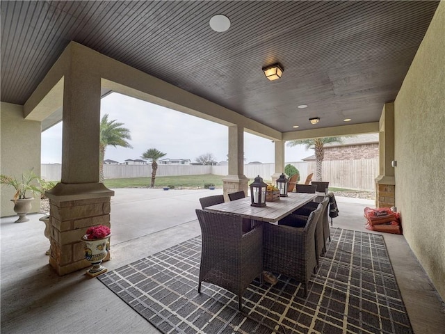 view of patio with outdoor dining area and a fenced backyard