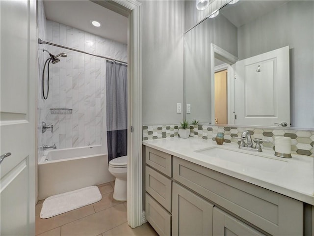 full bath featuring decorative backsplash, toilet, shower / tub combo with curtain, tile patterned floors, and vanity