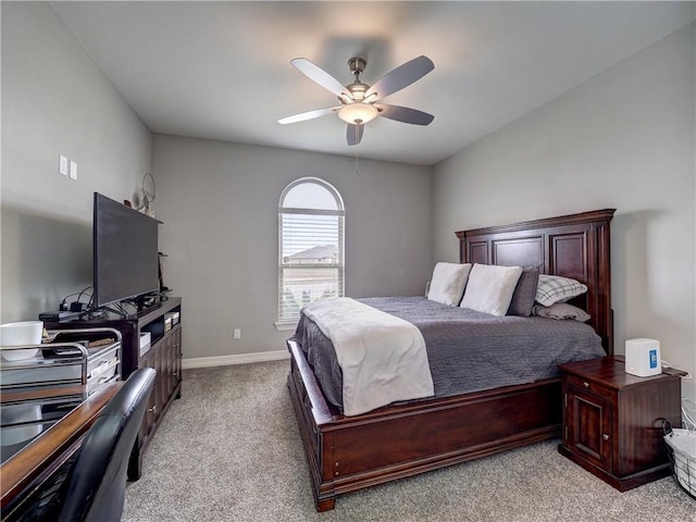 bedroom featuring baseboards, a ceiling fan, and light colored carpet