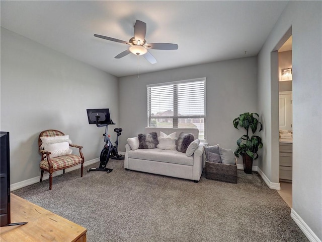 living room with a ceiling fan, carpet, and baseboards