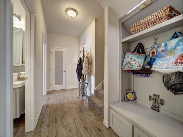 mudroom featuring light wood-type flooring and baseboards