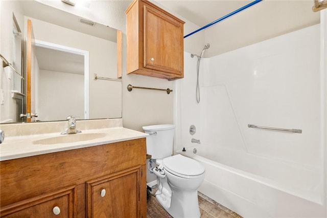 bathroom featuring visible vents, toilet, vanity, and  shower combination