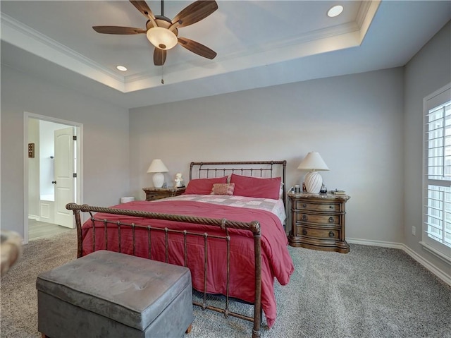 carpeted bedroom featuring a raised ceiling, ceiling fan, and crown molding