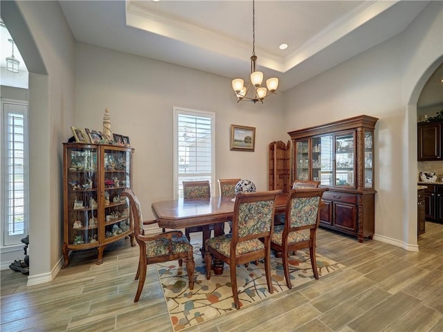 dining room featuring a tray ceiling and a chandelier