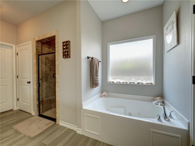 bathroom featuring shower with separate bathtub