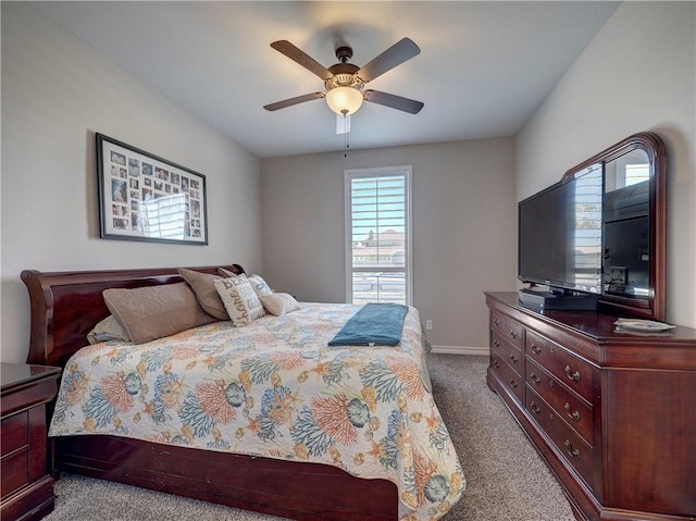 bedroom featuring ceiling fan and carpet