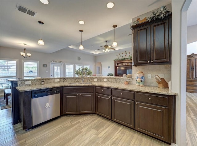 kitchen featuring kitchen peninsula, stainless steel dishwasher, dark brown cabinetry, and sink