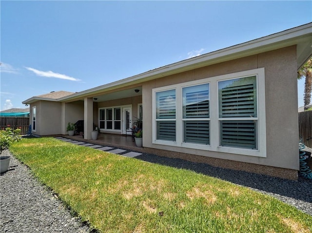 rear view of house featuring a yard