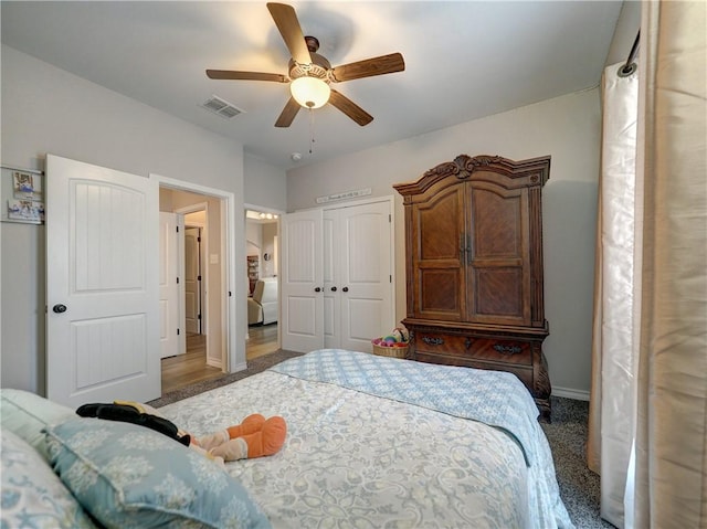 bedroom featuring dark colored carpet, ceiling fan, and a closet