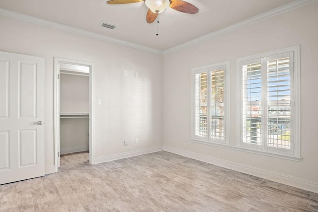 unfurnished bedroom featuring a closet, light hardwood / wood-style floors, ceiling fan, and ornamental molding