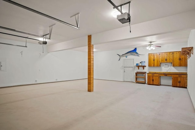 garage featuring ceiling fan, electric panel, and a garage door opener