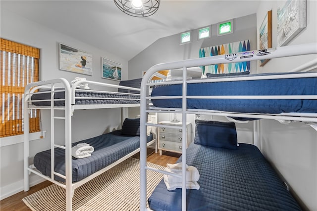 bedroom with hardwood / wood-style flooring and vaulted ceiling