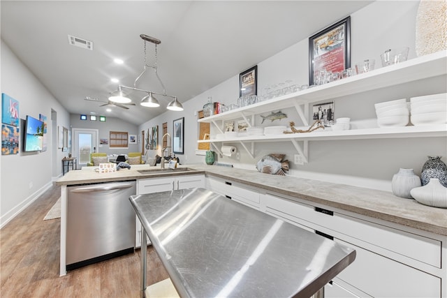 kitchen featuring white cabinetry, decorative light fixtures, sink, light hardwood / wood-style floors, and dishwasher