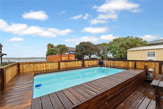 view of pool featuring a deck with water view