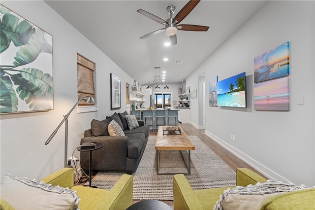 living room with wood-type flooring and ceiling fan