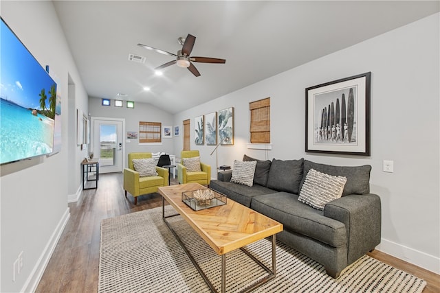 living room with wood-type flooring, ceiling fan, and vaulted ceiling