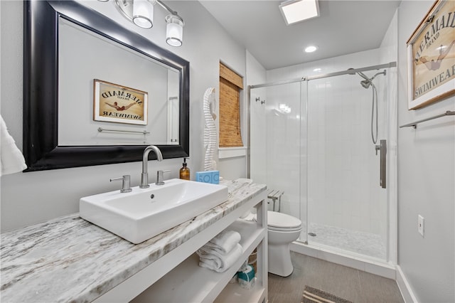 bathroom with a shower with door, tile patterned floors, sink, and toilet