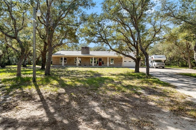 single story home with covered porch and a garage