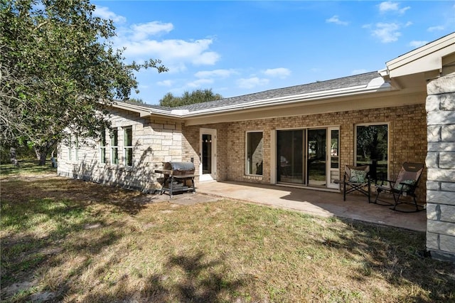 back of house with a yard and a patio