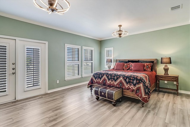 bedroom with light wood-type flooring, french doors, ornamental molding, and ceiling fan with notable chandelier