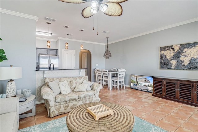 tiled living room featuring ceiling fan and ornamental molding