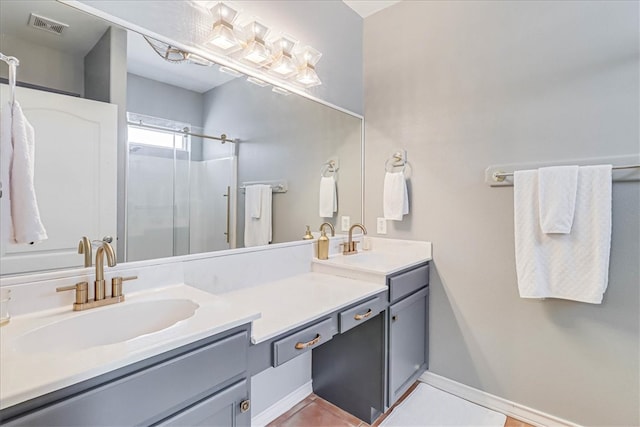 bathroom featuring vanity, tile patterned flooring, and a shower with shower door