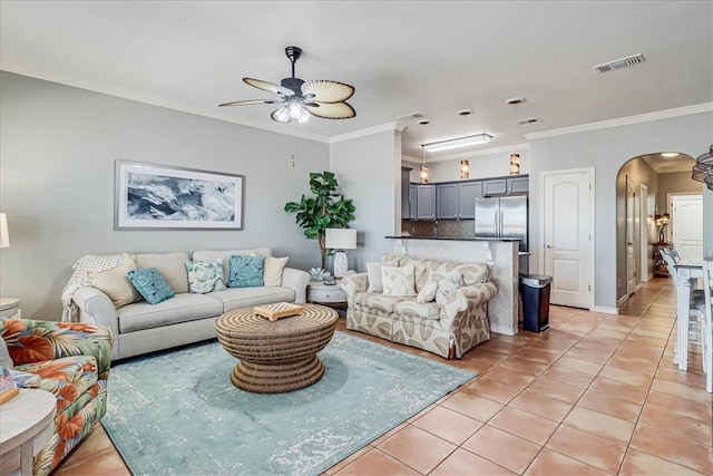 living room with ceiling fan, light tile patterned floors, and crown molding