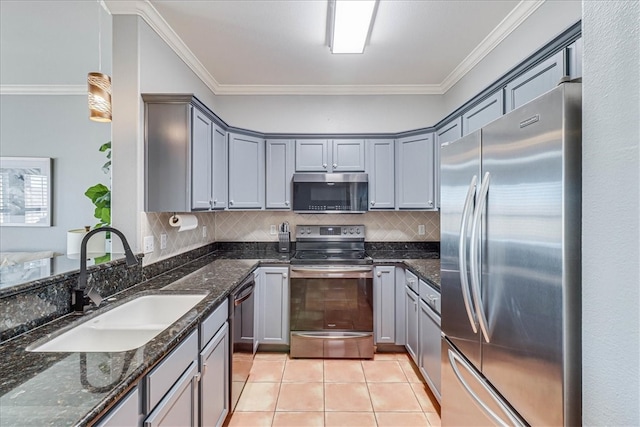 kitchen featuring sink, appliances with stainless steel finishes, dark stone counters, backsplash, and crown molding