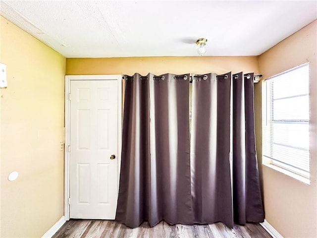 empty room featuring light wood-style floors and baseboards