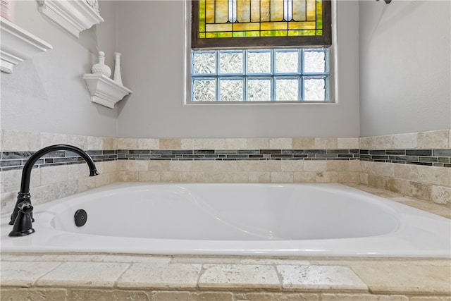 bathroom featuring tiled tub