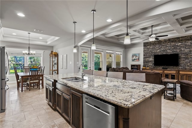 kitchen with stainless steel appliances, sink, hanging light fixtures, a kitchen island with sink, and coffered ceiling