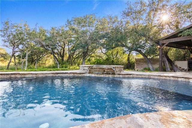 view of swimming pool with a hot tub and pool water feature