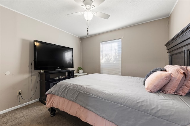 carpeted bedroom with a textured ceiling, ceiling fan, and ornamental molding