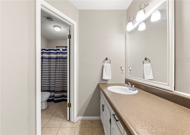 bathroom featuring tile patterned flooring, vanity, toilet, and curtained shower