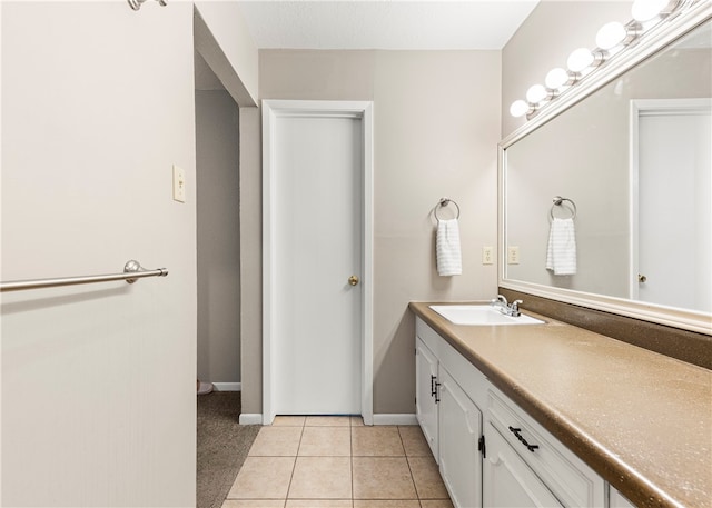 bathroom featuring tile patterned flooring and vanity