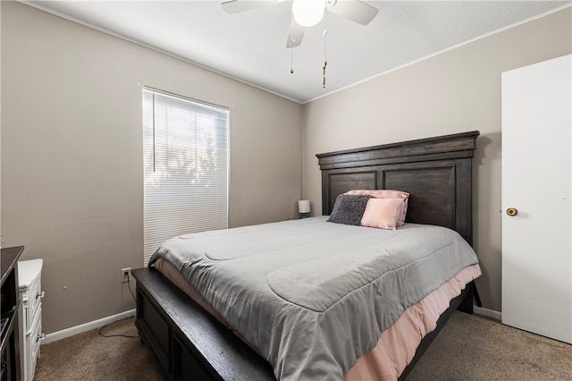 carpeted bedroom with ceiling fan and ornamental molding