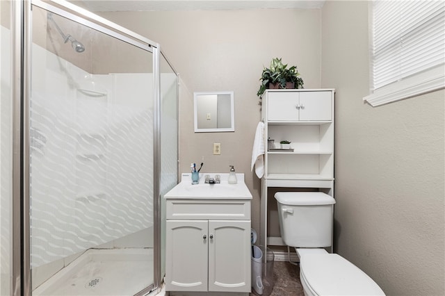 bathroom with vanity, toilet, and an enclosed shower