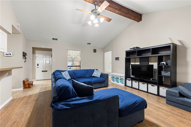 living room featuring lofted ceiling with beams, light hardwood / wood-style flooring, and ceiling fan