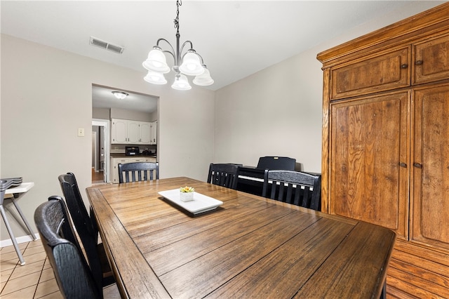 dining space with a chandelier and light tile patterned flooring