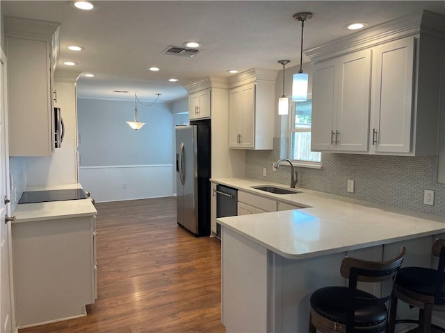 4513 Snead Dr, Corpus Christi, TX 78413 - kitchen featuring stainless steel appliances, a sink, dark wood-style floors, decorative backsplash, and recessed lighting