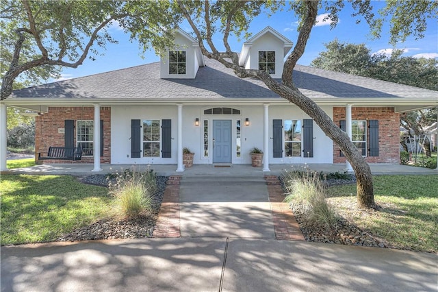 view of front of home with covered porch and a front yard