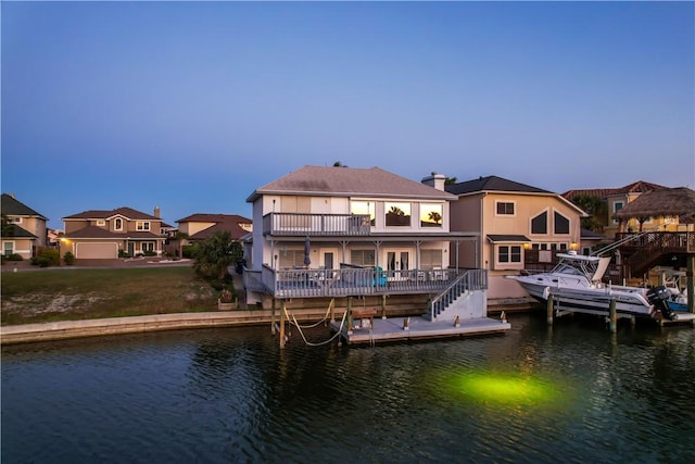 view of dock featuring a water view and a balcony
