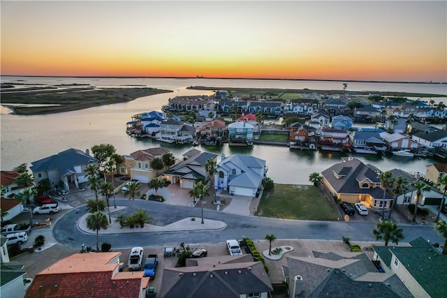 bird's eye view featuring a water view and a residential view