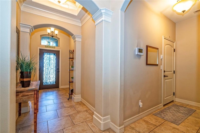 3918 Willow Heights Dr, Corpus Christi, TX 78410 - entryway featuring arched walkways, decorative columns, ornamental molding, light tile patterned floors, and a chandelier