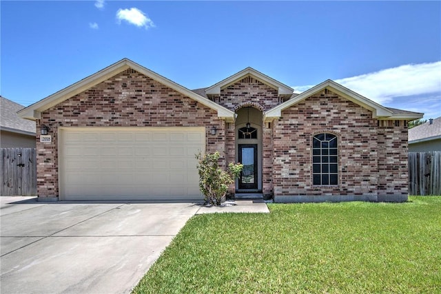 3918 Willow Heights Dr, Corpus Christi, TX 78410 - view of front facade featuring brick siding, a garage, and concrete driveway