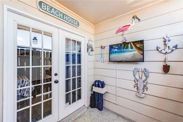 doorway to outside featuring wooden walls