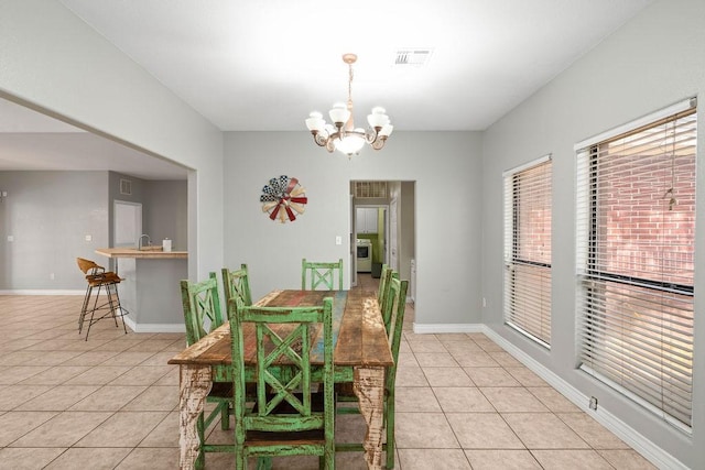 2214 N Mccampbell St, Aransas Pass, TX 78336 - dining space with light tile patterned flooring and a chandelier