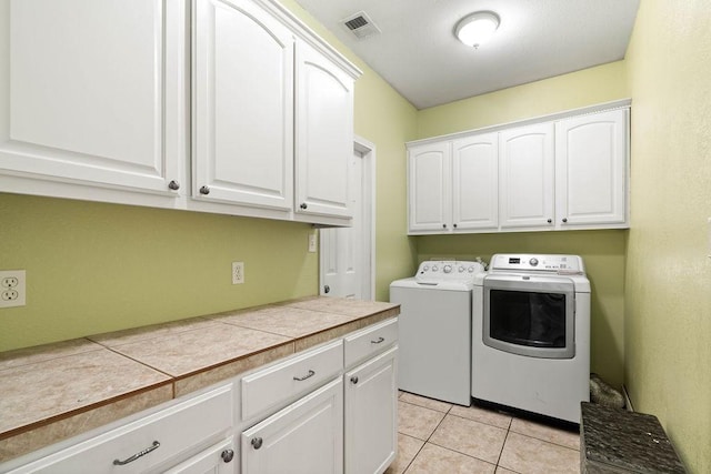 2214 N Mccampbell St, Aransas Pass, TX 78336 - washroom with cabinet space, separate washer and dryer, and light tile patterned flooring